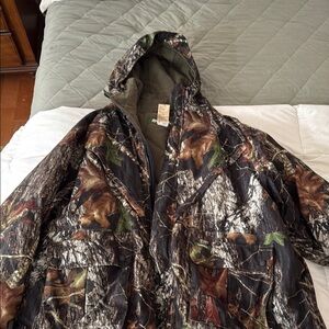 Hunting Coat
Remington Green and Brown Performance Jacket with Camouflage Design